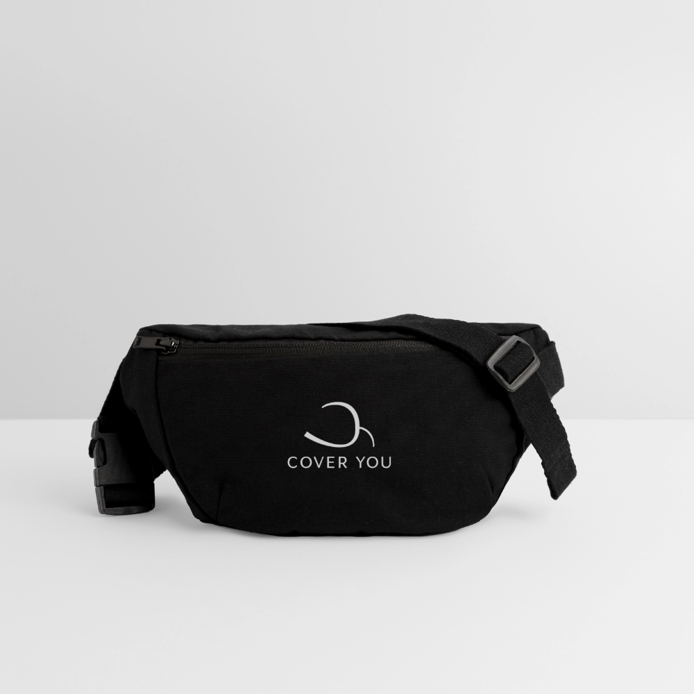 Sac banane COVER YOU noir posé de trois-quarts, sangle et boucle à clip visibles
